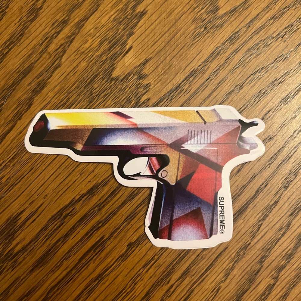 SUPREME MENDINI GUN
STICKER SS16